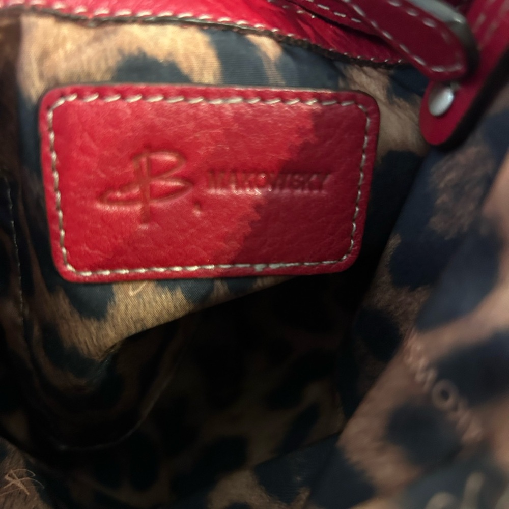 B. Makowsky red leather crossbody bag with a leopard lining. - Picture 5 of 8